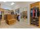 Spacious walk-in closet with custom wooden shelves and ample storage at 3937 E Norcroft Cir, Mesa, AZ 85215