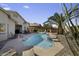 Sparkling pool and backyard with built-in steps, lush palm trees, and comfortable lounge chairs at 40830 W Bedford Dr, Maricopa, AZ 85138