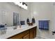 Well-maintained bathroom featuring a single sink vanity and a large mirror at 40830 W Bedford Dr, Maricopa, AZ 85138