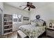 Comfortable bedroom with wood floors, a decorative wreath and white paneled walls at 40830 W Bedford Dr, Maricopa, AZ 85138