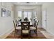 Bright dining room area featuring large windows and seating for six, perfect for entertaining at 40830 W Bedford Dr, Maricopa, AZ 85138