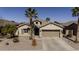 Charming single-story home with a two-car garage, desert landscaping, and a welcoming entrance at 40830 W Bedford Dr, Maricopa, AZ 85138