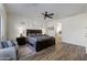 Serene main bedroom boasting wood floors, ample natural light, and a luxurious en-suite bathroom at 40830 W Bedford Dr, Maricopa, AZ 85138