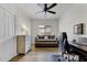 Office space with wood flooring, a daybed, natural light, and a modern desk setup at 40830 W Bedford Dr, Maricopa, AZ 85138