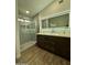 Bathroom with double vanity, illuminated mirror, and glass-enclosed shower at 4102 E Meadow Dr, Phoenix, AZ 85032