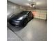 Spacious garage with epoxy flooring, parked car, and overhead lighting at 4102 E Meadow Dr, Phoenix, AZ 85032