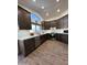 Modern kitchen featuring stainless steel appliances, quartz countertops, and dark wood cabinetry at 4102 E Meadow Dr, Phoenix, AZ 85032