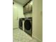 Functional laundry room with modern washer and dryer units and storage at 4102 E Meadow Dr, Phoenix, AZ 85032