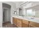 Well-lit primary bathroom with double sinks, a large mirror, and natural wood cabinets at 4171 E Dublin Ct, Gilbert, AZ 85295