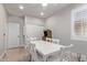 Dining room features white table and chairs, light grey walls, a game table, and wood floors at 4171 E Dublin Ct, Gilbert, AZ 85295