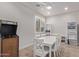 Bright dining room features a game table, white chairs, ample natural light, and light wood floors at 4171 E Dublin Ct, Gilbert, AZ 85295