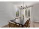 Dining area with a dark table, wood chairs, and plantation shutters for natural light at 4171 E Dublin Ct, Gilbert, AZ 85295