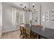 Bright dining area with wood floors, plantation shutters, dark table and a modern chandelier at 4171 E Dublin Ct, Gilbert, AZ 85295