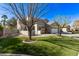 An exterior view of a well-maintained home with a front yard, two-car garage, and desert landscaping at 4171 E Dublin Ct, Gilbert, AZ 85295