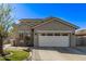 A sunlit view of a well maintained house, with a front yard, two car garage and desert landscaping at 4171 E Dublin Ct, Gilbert, AZ 85295