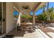 Outdoor patio dining area complete with ceiling fan, lights, grill and lounge chairs at 4171 E Dublin Ct, Gilbert, AZ 85295