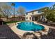 Inviting backyard oasis with a sparkling pool, lush green lawn, and mature landscaping at 4171 E Dublin Ct, Gilbert, AZ 85295