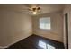 Cozy bedroom with a ceiling fan, window, and wood-look flooring at 4508 E Alta Vista Rd, Phoenix, AZ 85042