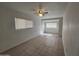 Bright bedroom featuring neutral walls, tile floors, ceiling fan, and natural light through window at 4508 E Alta Vista Rd, Phoenix, AZ 85042