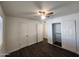 Spacious bedroom with wood floors, closet with sliding doors, and new ceiling fan at 4508 E Alta Vista Rd, Phoenix, AZ 85042