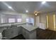 Updated kitchen featuring granite countertops, gray cabinets, and a pass-through window at 4508 E Alta Vista Rd, Phoenix, AZ 85042