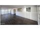 Bright living room with dark floors, white walls, and an open layout at 4508 E Alta Vista Rd, Phoenix, AZ 85042