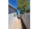 View of exterior walkway with brick path, painted fence, desert landscaping, and home exterior at 4508 E Alta Vista Rd, Phoenix, AZ 85042