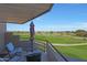 Enjoy beautiful golf course views from this balcony with comfortable seating and an umbrella for shade at 4850 E Desert Cove Ave # 333, Scottsdale, AZ 85254