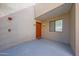 Inviting front entrance with covered porch, orange door and a view of the window at 4850 E Desert Cove Ave # 333, Scottsdale, AZ 85254