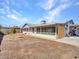 Wide open backyard with a screened in porch, a tree, and long driveway leading to the garage at 4929 W Christy Dr, Glendale, AZ 85304