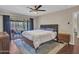 Bright bedroom featuring a ceiling fan, hardwood floors, and natural light from the covered patio access at 4929 W Christy Dr, Glendale, AZ 85304