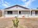 Charming single-story home with a white brick facade and a cozy front porch at 4929 W Christy Dr, Glendale, AZ 85304