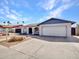 Exterior view of a single Gathering home with a two-car garage, arched entryway, rock landscaping, and suburban street view at 4929 W Christy Dr, Glendale, AZ 85304