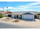 The front exterior of a home featuring a two-car garage, arched entryway and landscaping with an appealing suburban aesthetic at 4929 W Christy Dr, Glendale, AZ 85304