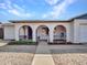 A welcoming front porch with decorative arches and well-maintained landscaping at 4929 W Christy Dr, Glendale, AZ 85304