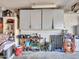 Garage featuring storage cabinets, shelving, and a workbench at 4929 W Christy Dr, Glendale, AZ 85304