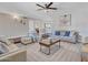 Open living room featuring a ceiling fan, large windows, and a neutral color palette at 4929 W Christy Dr, Glendale, AZ 85304