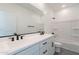 Bathroom with a double sink vanity, black hardware, and a shower-tub combo at 5038 W Cheryl Dr, Glendale, AZ 85302