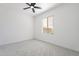 Bright bedroom featuring neutral walls, ceiling fan, and window with light-filtering blinds at 5038 W Cheryl Dr, Glendale, AZ 85302