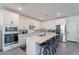 Well-equipped kitchen with quartz countertops, stainless steel appliances, and a large center island with bar seating at 5038 W Cheryl Dr, Glendale, AZ 85302