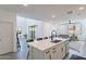 Spacious kitchen featuring a central island with seating and a view into the bright and open living spaces at 5038 W Cheryl Dr, Glendale, AZ 85302