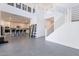 Bright, open living room with modern staircase, white walls, and tile floors adjacent to a contemporary kitchen at 5038 W Cheryl Dr, Glendale, AZ 85302