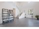 Bright living room with modern staircase, gray tile floor, and minimalist décor at 5038 W Cheryl Dr, Glendale, AZ 85302