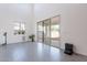 Bright living room features modern gray tile flooring, neutral paint, and sliding glass doors at 5038 W Cheryl Dr, Glendale, AZ 85302