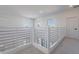 Bright loft space featuring modern railings, neutral carpet, and natural light at 5038 W Cheryl Dr, Glendale, AZ 85302