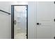 Bathroom featuring a walk-in shower with a black framed glass enclosure and chrome hardware at 5038 W Cheryl Dr, Glendale, AZ 85302