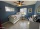 Cozy bedroom featuring a ceiling fan, tiled floor, and bright natural light at 5205 N 8Th Pl, Phoenix, AZ 85014