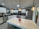 Bright kitchen with white cabinets, stainless steel appliances, decorative lighting, and a functional central island at 5205 N 8Th Pl, Phoenix, AZ 85014