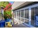 Inviting outdoor patio featuring white privacy shutters, a dining set, and vibrant flowering plants at 5205 N 8Th Pl, Phoenix, AZ 85014