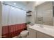 Bathroom featuring a vanity with sink, toilet, and a white and brown shower curtain at 523 S 201St Ave, Buckeye, AZ 85326